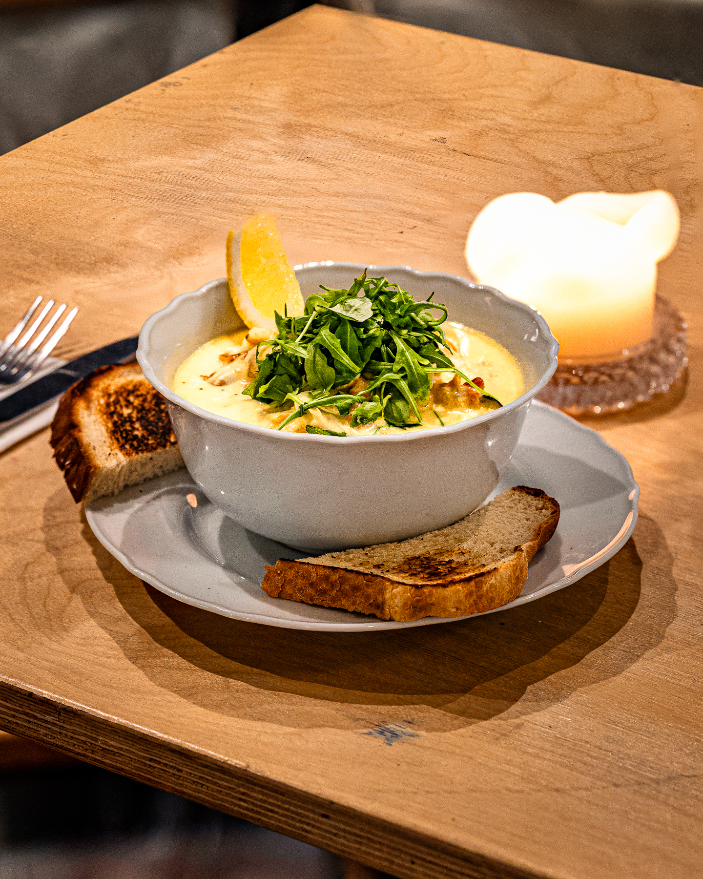 A bowl of seafood chowder with sourdough on the pass at Walters